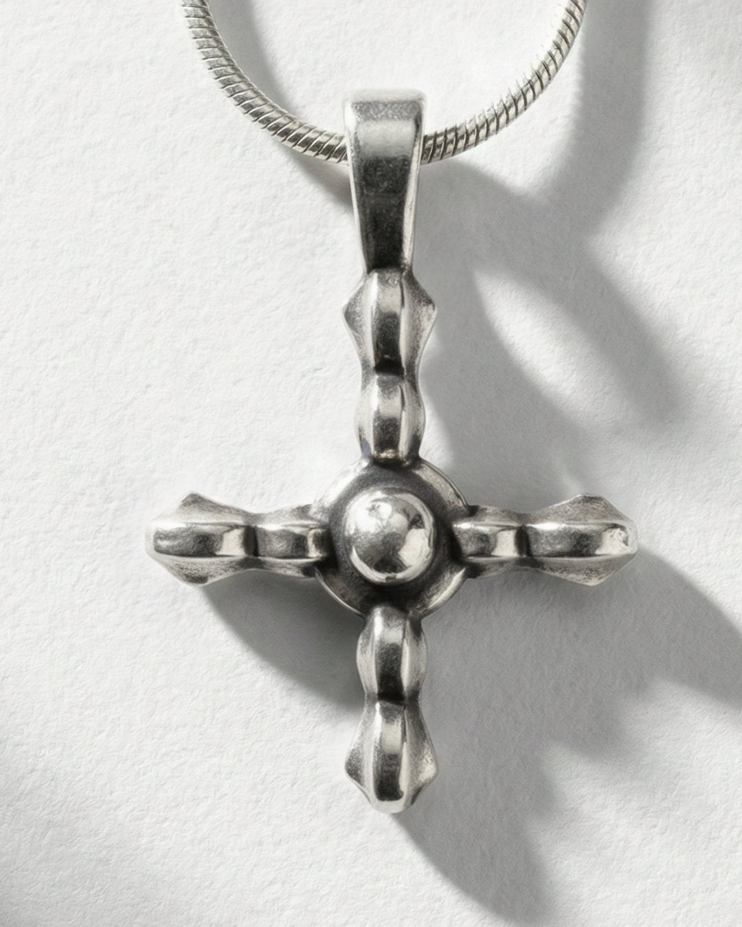 Axis Cross pendant worn, silver with snake chain