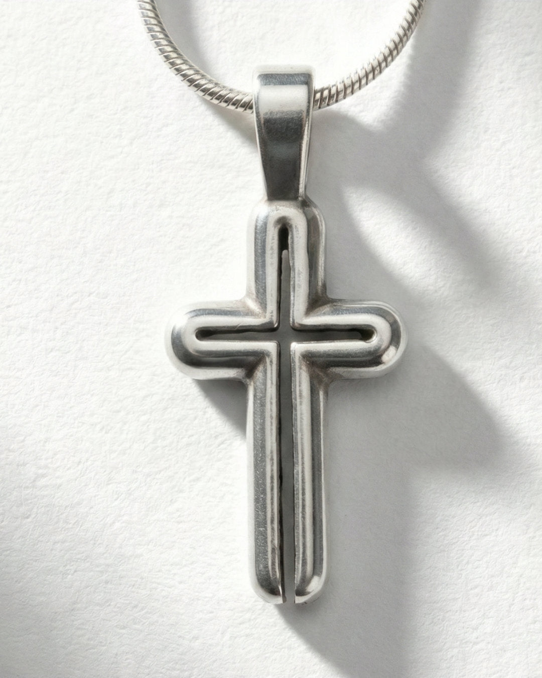 Neo Cross pendant worn, silver with snake chain