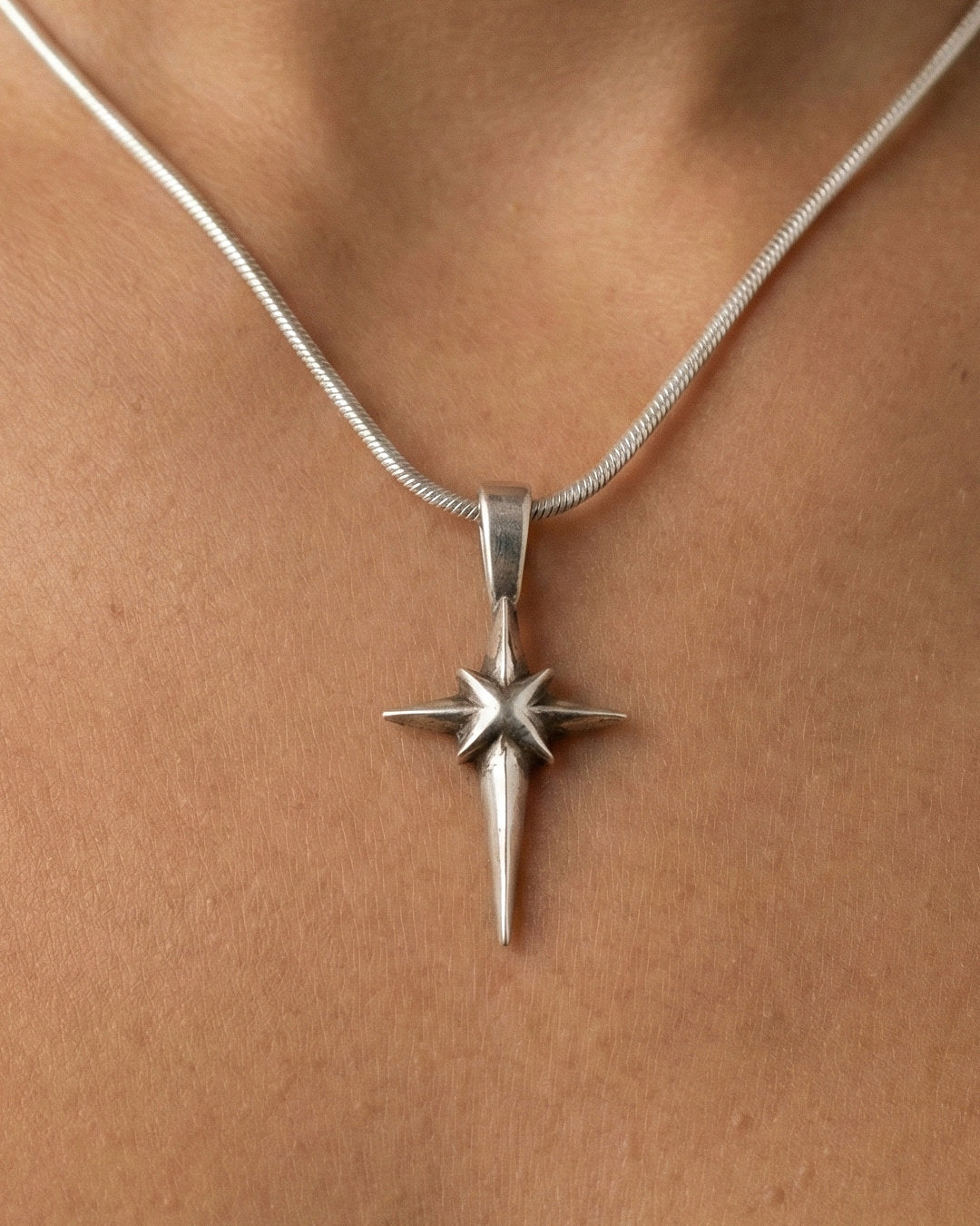 Guspira Cross pendant worn on a neck